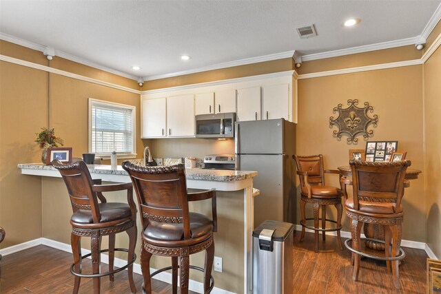 2536 22nd Ave N, Texas City, TX 77590 - kitchen with dark wood finished floors, stainless steel appliances, crown molding, and visible vents