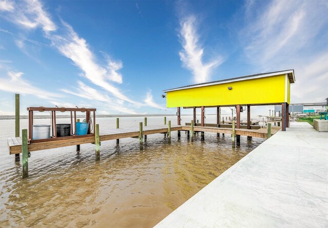 view of dock with boat lift and a water view