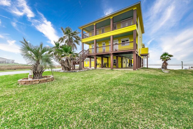 rear view of property with a yard
