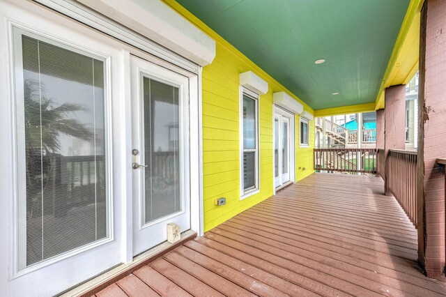 wooden deck featuring an AC wall unit