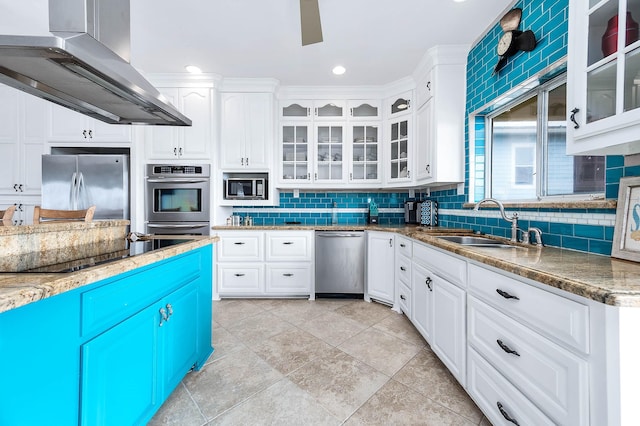 kitchen with white cabinetry, decorative backsplash, a sink, appliances with stainless steel finishes, and ventilation hood