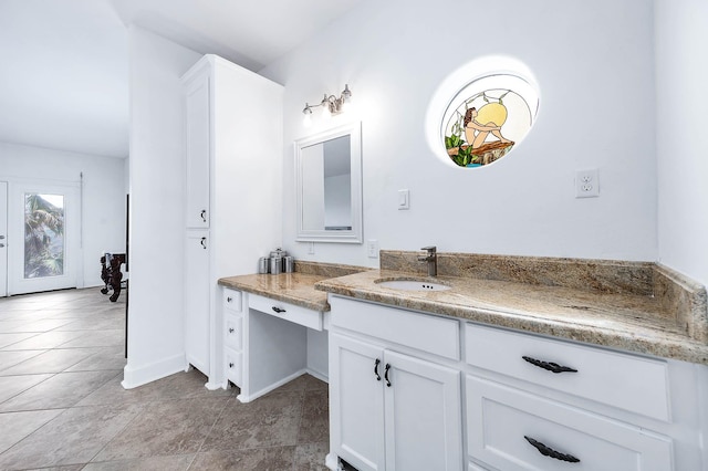 bathroom featuring tile patterned floors, baseboards, and vanity