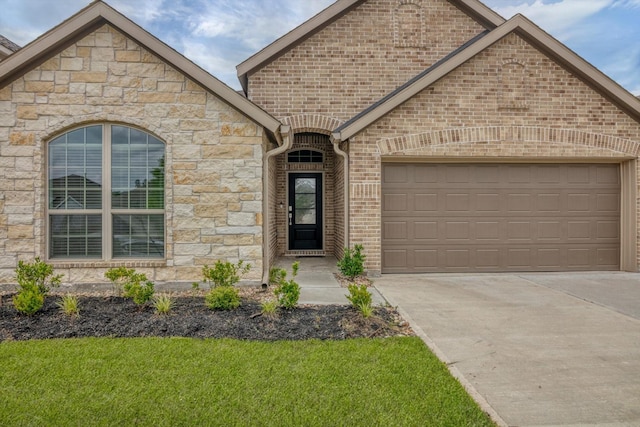 3148 Catalonion Ct, Conroe, TX 77301 - french country style house with a garage, driveway, stone siding, a front yard, and brick siding