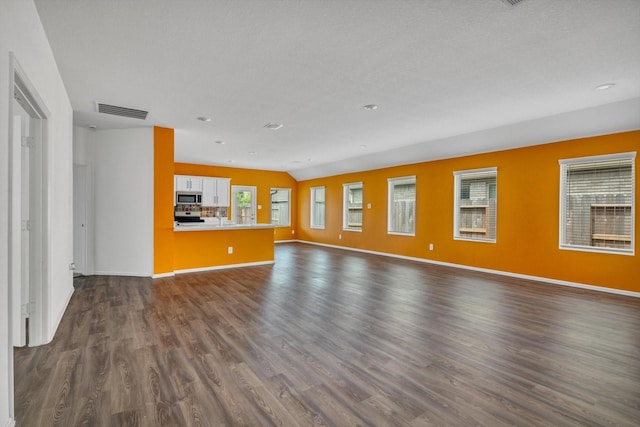 3148 Catalonion Ct, Conroe, TX 77301 - unfurnished living room featuring dark wood-style flooring and baseboards