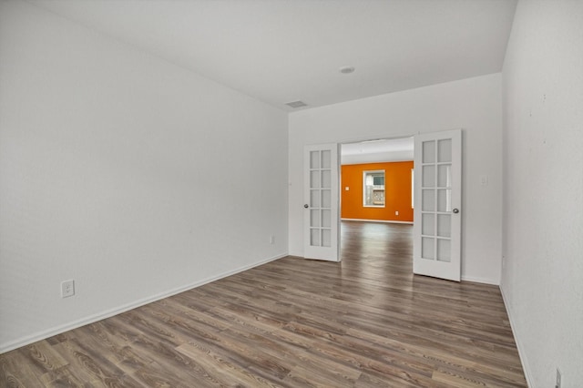 3148 Catalonion Ct, Conroe, TX 77301 - unfurnished room with french doors, dark wood finished floors, and baseboards
