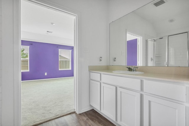 3148 Catalonion Ct, Conroe, TX 77301 - full bath with vanity, a shower with door, wood finished floors, and baseboards