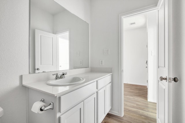 3148 Catalonion Ct, Conroe, TX 77301 - bathroom featuring wood finished floors, vanity, and baseboards