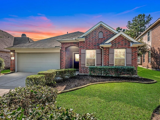 single story home featuring brick siding, a front yard, driveway, and a garage