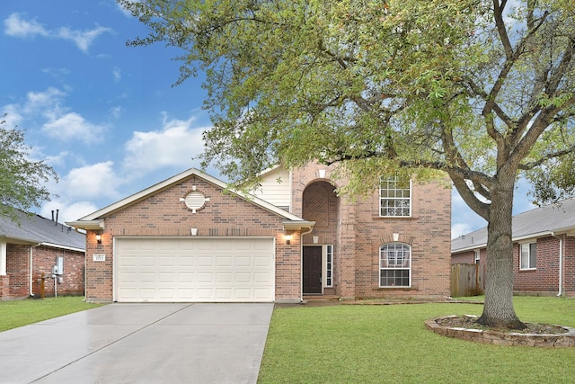 traditional-style house with a front yard, concrete driveway, fence, brick siding, and a garage