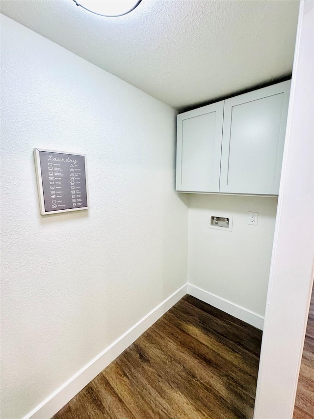 8522 Pearl Lake Dr, Houston, TX 77095 - washroom featuring cabinet space, dark wood-style flooring, washer hookup, baseboards, and a textured ceiling
