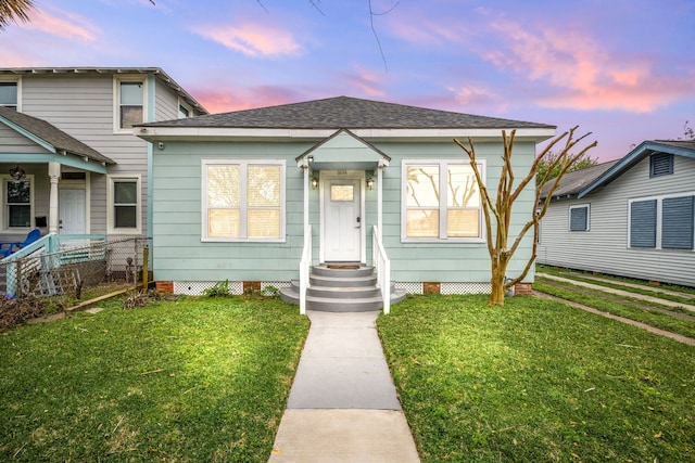 3529 Avenue S, Galveston, TX 77550 - bungalow-style home with roof with shingles, fence, and a front lawn