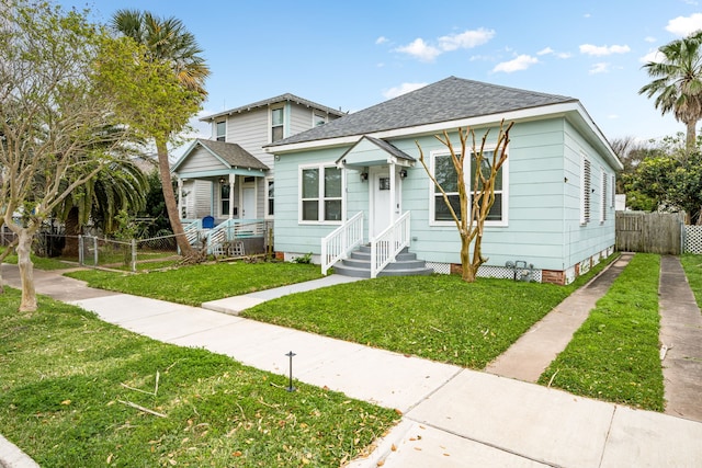 3529 Avenue S, Galveston, TX 77550 - bungalow-style home featuring a gate, fence, roof with shingles, and a front yard
