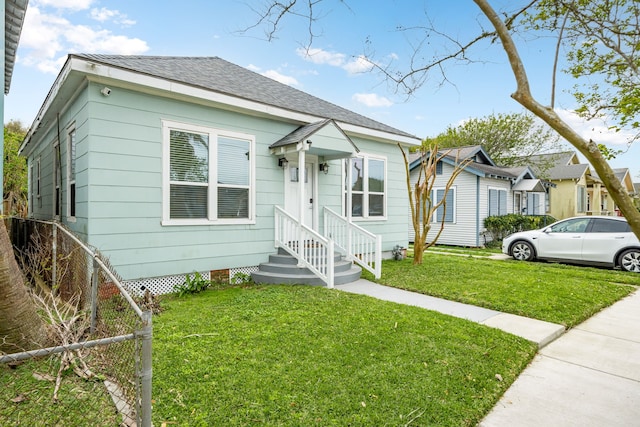 3529 Avenue S, Galveston, TX 77550 - bungalow with fence, a front lawn, and roof with shingles