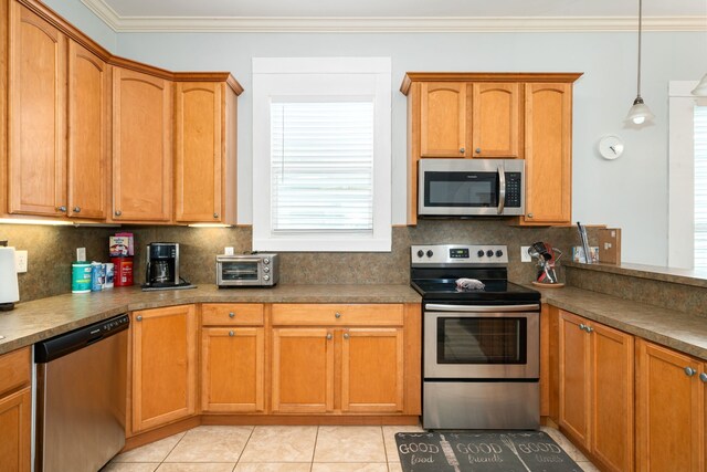 3529 Avenue S, Galveston, TX 77550 - kitchen featuring a toaster, backsplash, ornamental molding, and appliances with stainless steel finishes