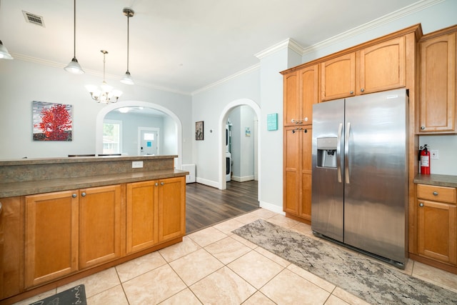 3529 Avenue S, Galveston, TX 77550 - kitchen with stainless steel fridge with ice dispenser, dark countertops, light tile patterned floors, visible vents, and arched walkways
