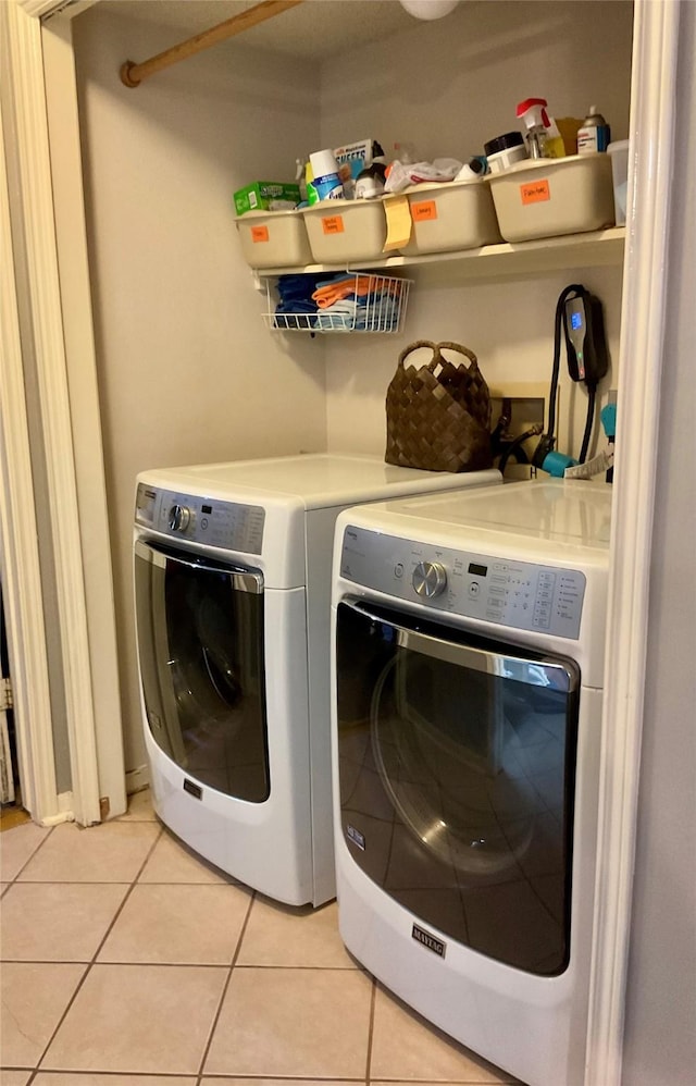 18146 River Sage Dr, Houston, TX 77084 - laundry room with washer and clothes dryer and light tile patterned flooring