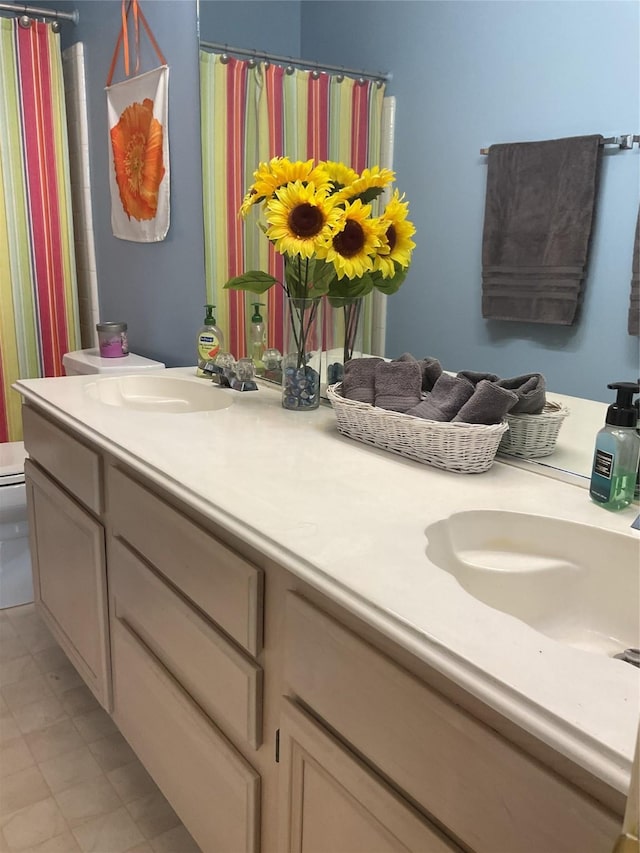 18146 River Sage Dr, Houston, TX 77084 - bathroom with double vanity, toilet, and curtained shower