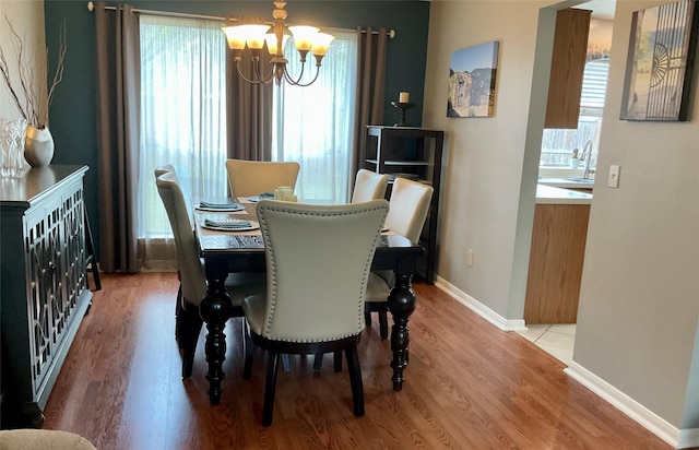 18146 River Sage Dr, Houston, TX 77084 - dining area with a chandelier, light wood-type flooring, and baseboards