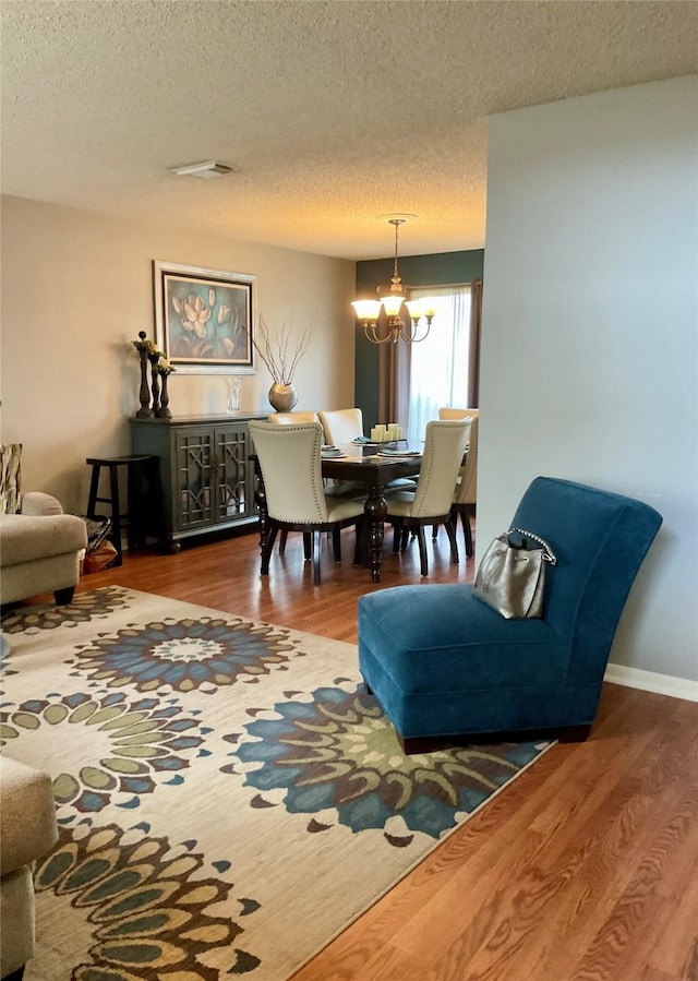 18146 River Sage Dr, Houston, TX 77084 - living room featuring a chandelier, wood finished floors, and a textured ceiling