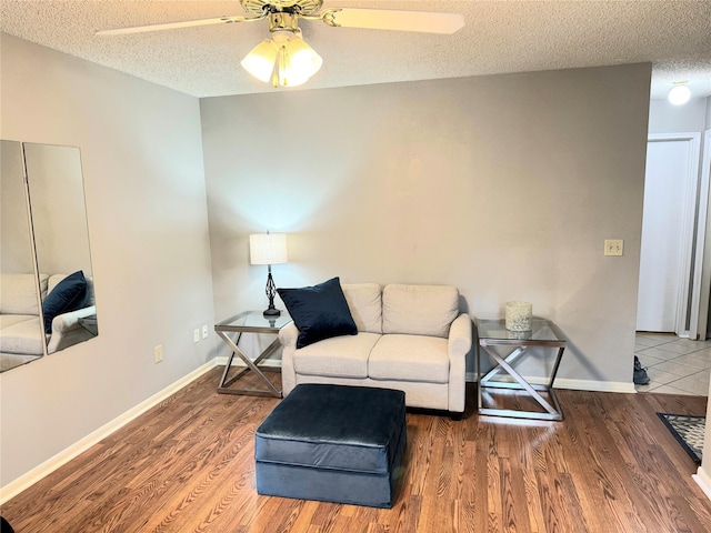 18146 River Sage Dr, Houston, TX 77084 - sitting room featuring a textured ceiling, ceiling fan, wood finished floors, and baseboards