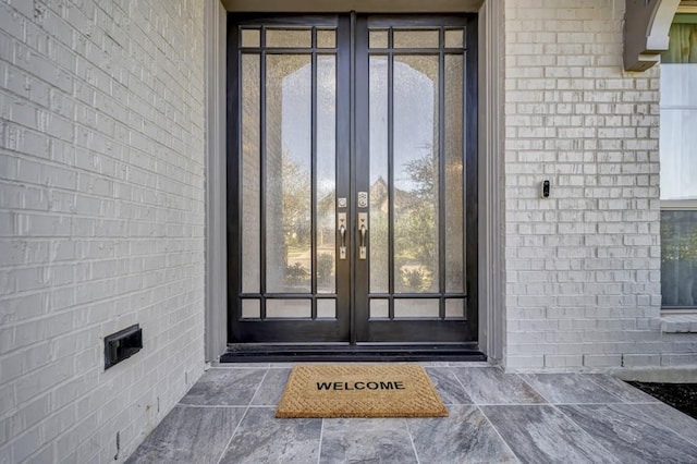 28902 Ridge Valley Ct, Fulshear, TX 77441 - view of exterior entry featuring french doors and brick siding