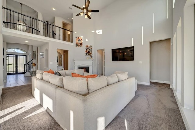 28902 Ridge Valley Ct, Fulshear, TX 77441 - living area with carpet, a high ceiling, baseboards, a ceiling fan, and a fireplace