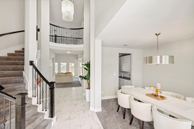 28902 Ridge Valley Ct, Fulshear, TX 77441 - dining room featuring light marble finish floors, baseboards, and stairs
