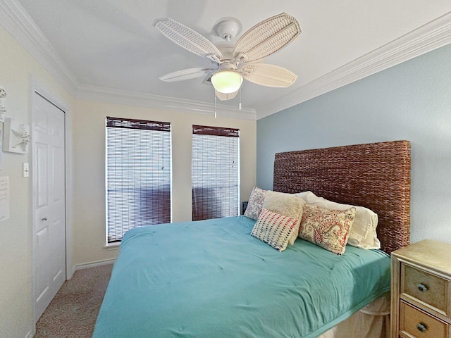 carpeted bedroom with a ceiling fan and crown molding