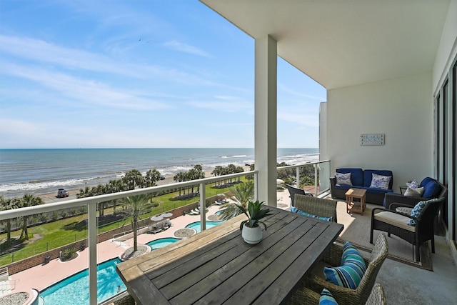 balcony featuring a water view, a view of the beach, and outdoor lounge area