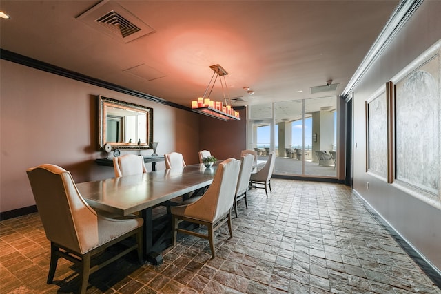 dining area featuring baseboards, ornamental molding, visible vents, and an inviting chandelier