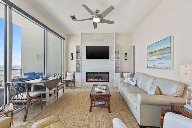 living room featuring a fireplace, built in features, ceiling fan, and visible vents