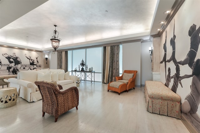 living room with light wood-type flooring and a raised ceiling