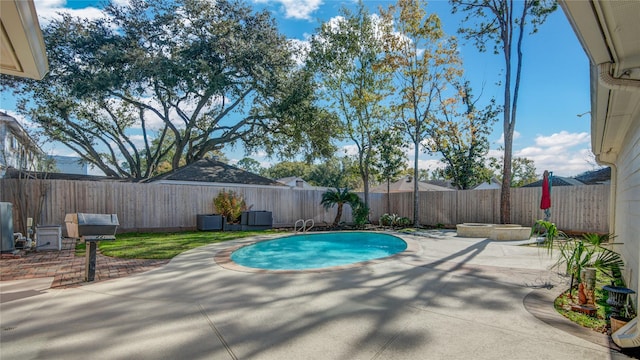 view of swimming pool with a fenced backyard and a patio