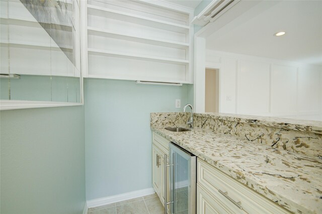 bar featuring recessed lighting, wine cooler, a sink, baseboards, and indoor wet bar