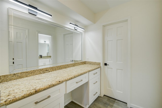 bathroom featuring vanity and wood finished floors