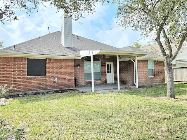 back of house featuring a yard, brick siding, a ceiling fan, and a patio