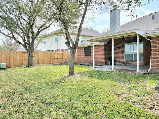 view of yard featuring fence, a patio area, and a ceiling fan