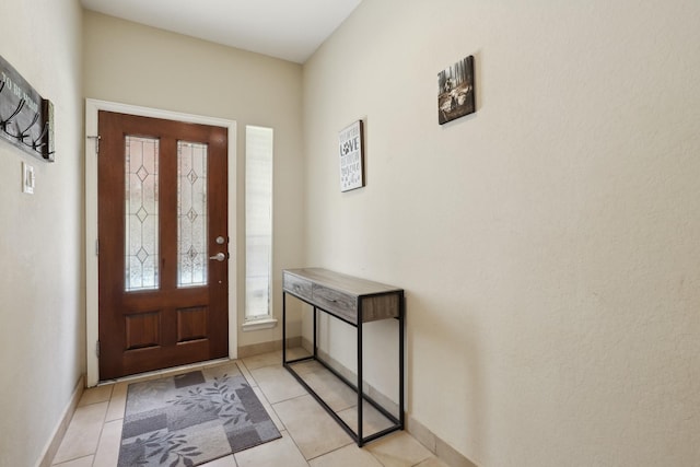 foyer entrance with baseboards and light tile patterned flooring