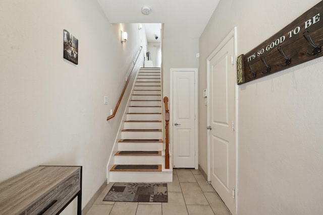 staircase with tile patterned flooring and baseboards