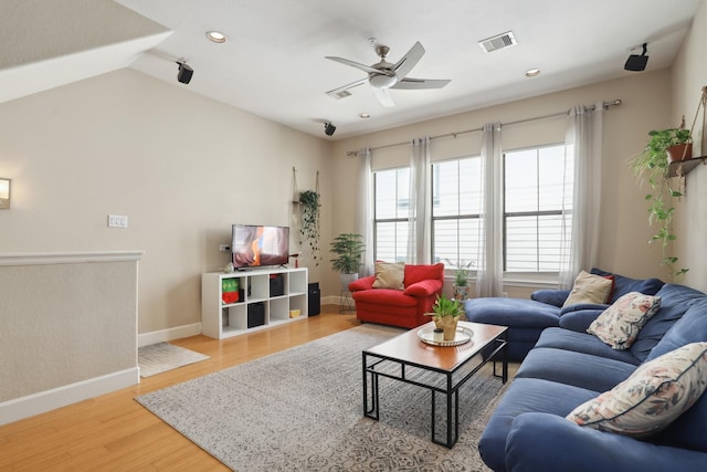 living area with a ceiling fan, baseboards, light wood-type flooring, recessed lighting, and vaulted ceiling