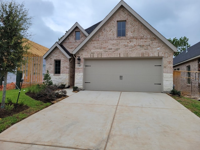 328 Rise Ln, Montgomery, TX 77316 - view of front of house featuring driveway, a garage, and brick siding