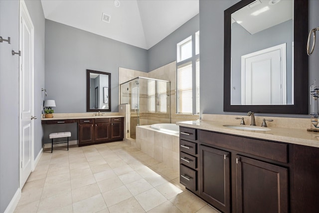 bathroom featuring tile patterned floors, a sink, a stall shower, and a garden tub