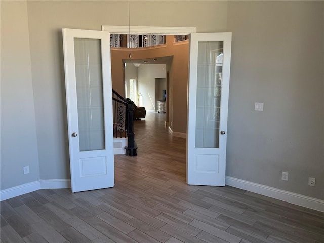 29431 Amber Meadows Ct, Katy, TX 77494 - unfurnished room with dark wood-style floors, baseboards, and stairway