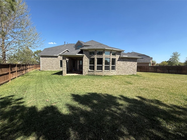 29431 Amber Meadows Ct, Katy, TX 77494 - back of house featuring a fenced backyard, brick siding, and a yard
