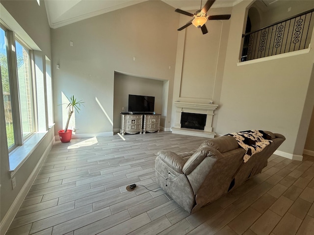 29431 Amber Meadows Ct, Katy, TX 77494 - living area featuring wood finish floors, high vaulted ceiling, baseboards, a high end fireplace, and a ceiling fan