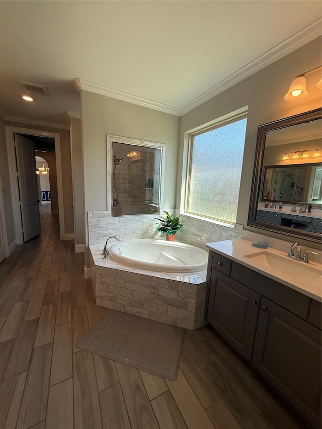 29431 Amber Meadows Ct, Katy, TX 77494 - bathroom featuring a garden tub, wood finish floors, and crown molding
