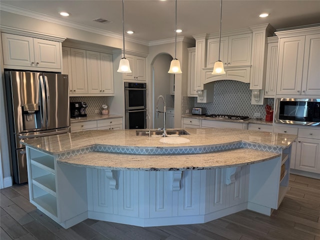 29431 Amber Meadows Ct, Katy, TX 77494 - kitchen with a sink, white cabinetry, wood finished floors, appliances with stainless steel finishes, and visible vents