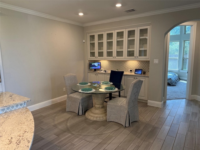 29431 Amber Meadows Ct, Katy, TX 77494 - dining room with wood finish floors, arched walkways, crown molding, and visible vents