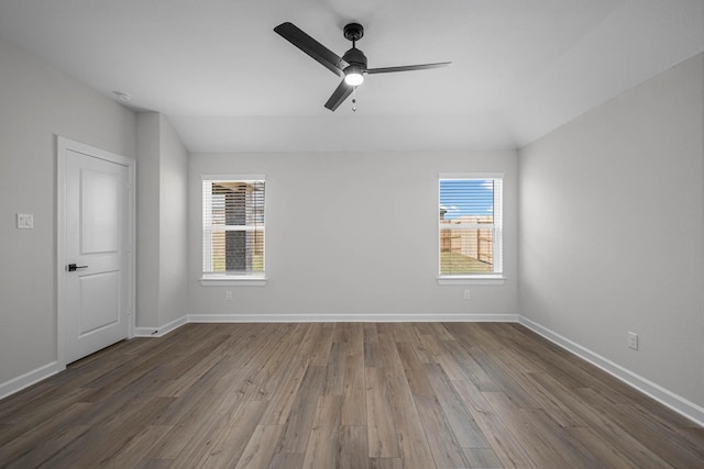 empty room featuring ceiling fan, wood finished floors, and a healthy amount of sunlight