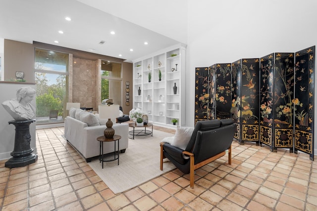 9171 Briar Frst, Houston, TX 77024 - living room featuring recessed lighting, built in features, and stone tile flooring